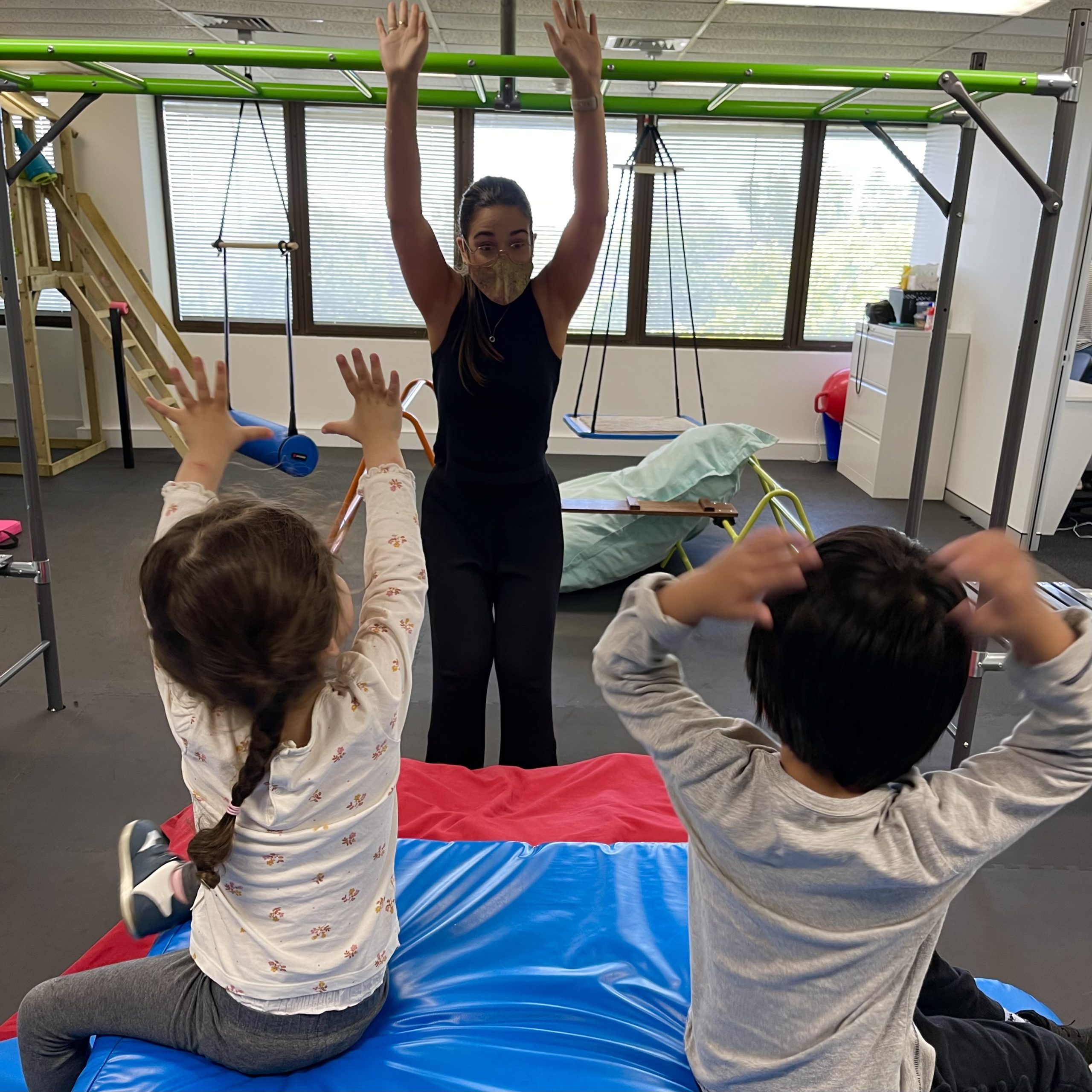Two young children with autism doing the Early Start Denver Model ESDM in an Occupational Therapy gym at Bondi Junction Sydney